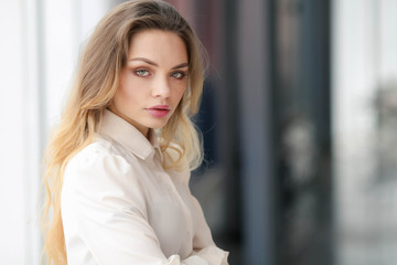 Fototapeta premium A woman in a business suit. Long hair and red lips