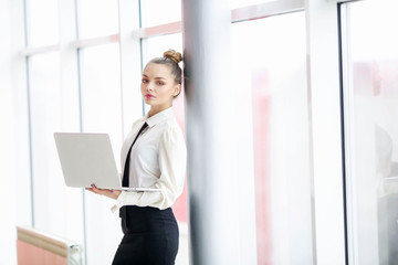 Fototapeta premium Business woman in blouse and skirt makes entries in a notebook at office center.