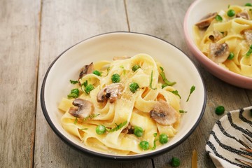 Homemade Fettuccine Alfredo with mushrooms and green peas