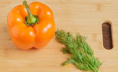 Bulgarian sweet pepper and dill on the cutting Board.