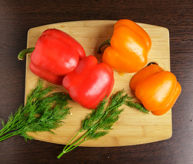 Bulgarian sweet pepper slices and dill on the cutting Board.
