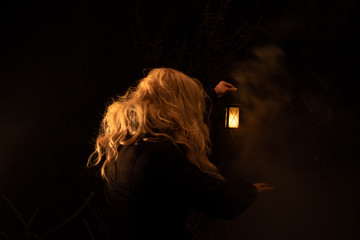 Silhouette of a woman holding lantern in the night. scary scene © Emil