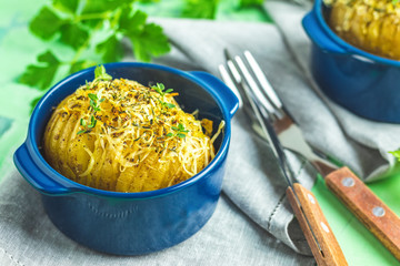 Delicious portion baked potatoes in cocotte blue ceramic baking molds
