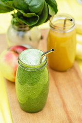 Two colorful fruit smoothies in glass jars