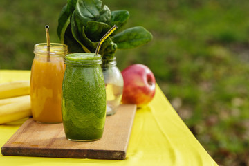 Two colorful fruit smoothies in glass jars