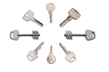 the keys to the door locks lie in a circle on white
