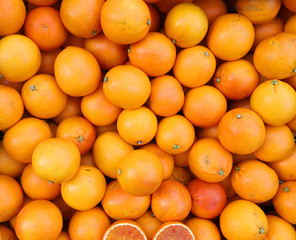 background of ripe orange oranges for sale at supermarket