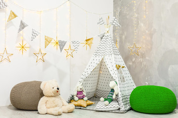Stylish modern children room. Kid's wigwam in children room. wooden star lamp. Interior scandinavian style. © Angelov