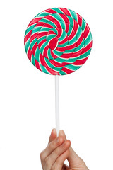 round candy in hand. Spiral lolly on a white background. Sweets