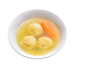 Traditional matzoh ball (kneidlach) soup.White bowl with authentic matzo ball chicken taste hot soup ( bouillon ) isolated on white background. Jewish food for Passover and every day.