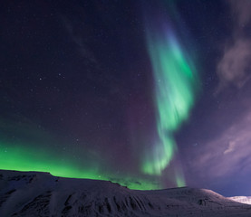 The polar arctic Northern lights aurora borealis sky star in Norway travel Svalbard in Longyearbyen city the moon mountains