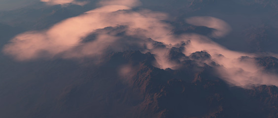 Aerial of mountains covered in clouds.