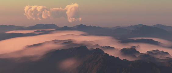 Mountains in fog with cloudy sky at sunrise.