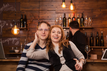 Couple On Date Sitting At Bar Counter And smiling
