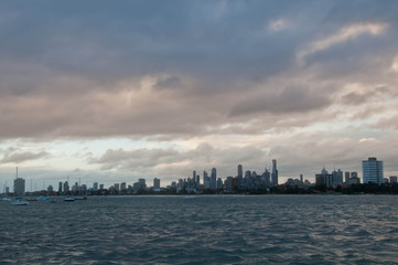 Naklejka premium Wide angle evening scene of skyscrapers horizon with ocean and tall office and residential towers in Melbourne Australia