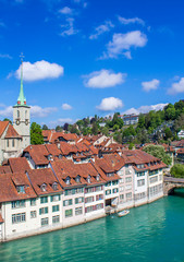 Fototapeta na wymiar View of Bern. Aare river. Church Nidde Kirche