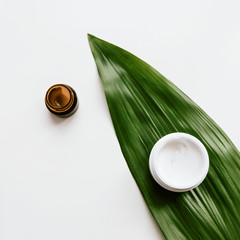 Skincare products Flat lay photo Two different jars of facial cream are standing on a white...