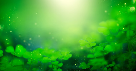 St. Patrick's Day green blurred background with shamrock leaves. Patrick Day. Abstract border art design. Magic clover nature backdrop