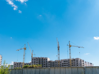 Construction site with many cranes against the sky