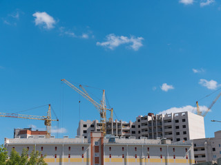 Construction site with many cranes against the sky