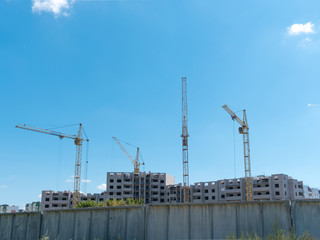 Construction site with many cranes against the sky