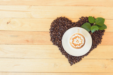 hot cappuccino with nice milk pattern with coffee bean heart shape / coffee with love 