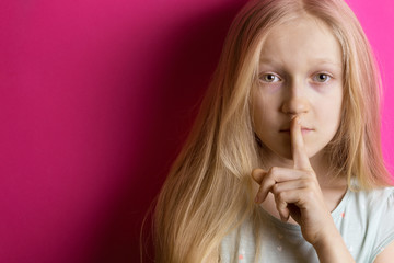 Fototapeta premium little girl blonde on a pink background