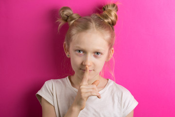 Fototapeta premium little girl blonde on a pink background