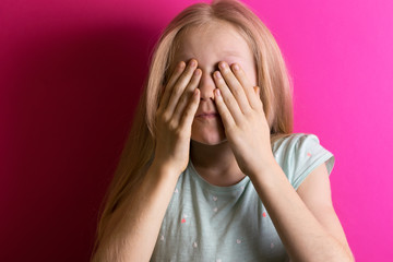 Fototapeta premium little girl blonde on a pink background