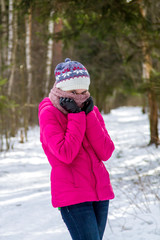 Fototapeta na wymiar Portrait of a girl in the winter forest.