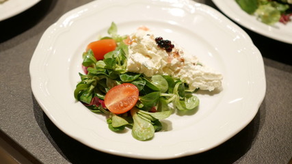 Fresh salad, valerian, tomato, cheese, caviar