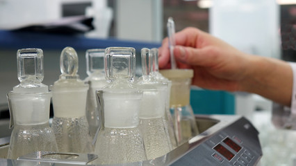 A female laboratory assistant checks samples of dairy products in the laboratory.