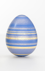 One Easter egg concept with striped golden decoration
