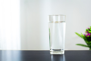 Glass of water on the table background