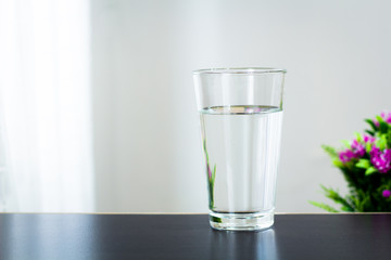 Glass of water on the table background