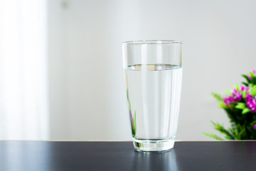 Glass of water on the table background