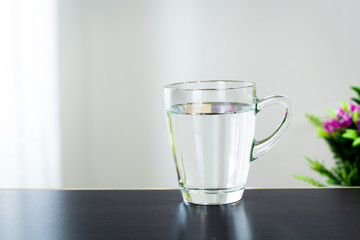 Glass of water on the table background
