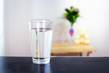 Glass of water on the table background