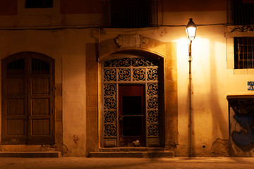 Door at Barrio el Born at night with street lights, Barcelona, Spain