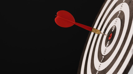 Dartboard with dart in center. Concept of target in business and success