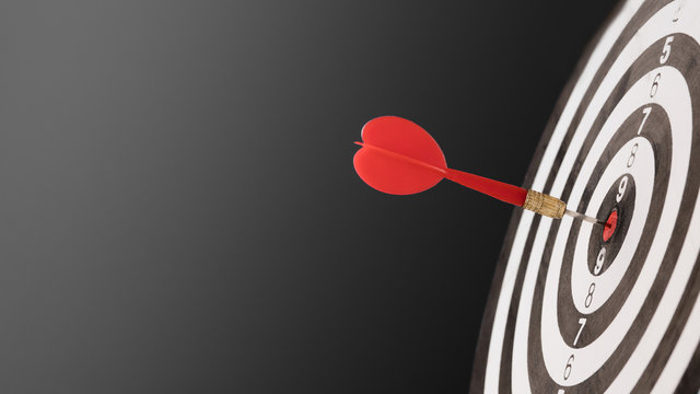 Dartboard with dart in center. Concept of target in business and success