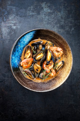 Traditional French Corsican seafood stew with prawns and mussels as top view in a modern design Japanese bowl