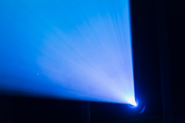 A beam of light from the projector in the cinema. Theatre equipment. Abstract background.
