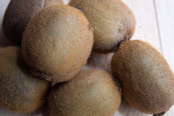 lots of kiwi on a wooden table