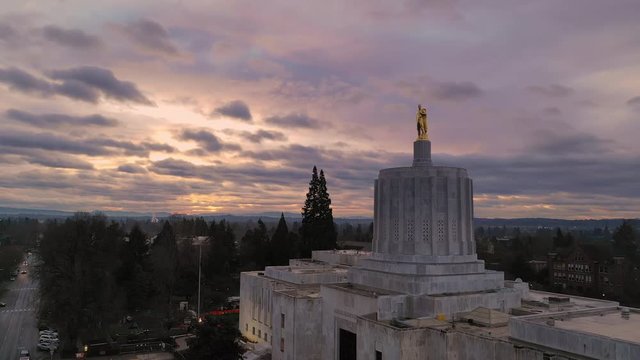Morning Traffic Passes the Oregon Pioneer atop the Capital Building Salem