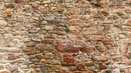 Medieval Stone Wall Texture. Old brick and stone wall with thick grout and very rough, irregular surface.