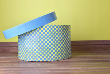 decorative hatbox whith open lid on wooden floor