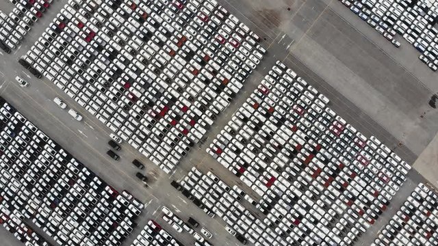 Transportation aerial view from drone top view new cars lined up in the port for import and export.Stock waiting for export