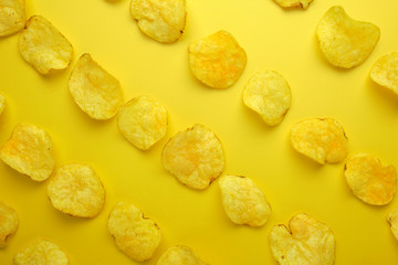 Potato chips flat lay on yellow background top view