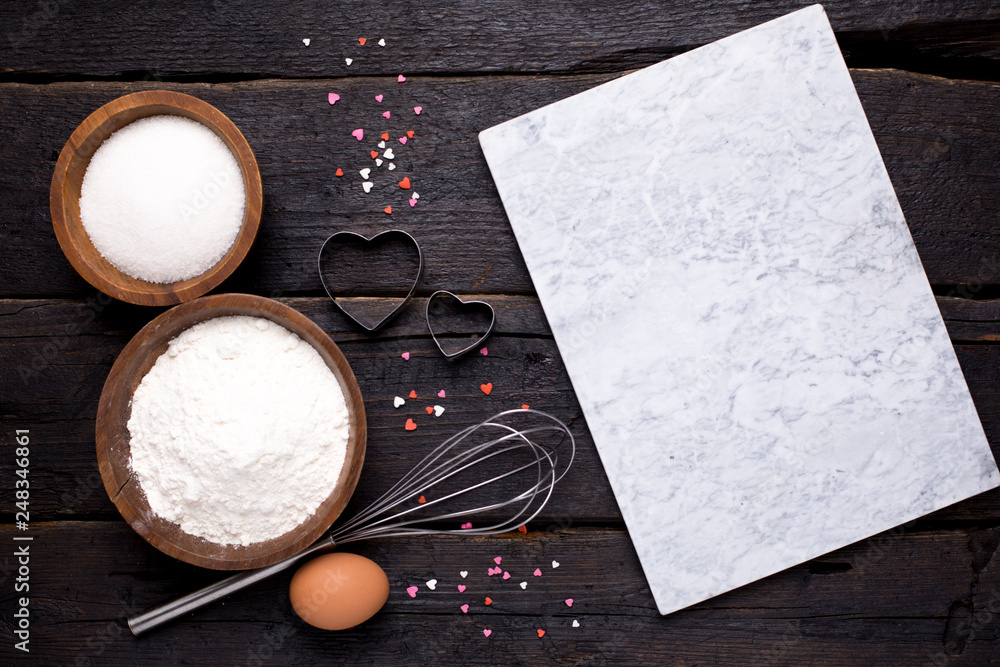 Wall mural kitchen tools, flour and sugar on a wooden background